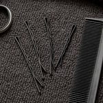 Detailed close-up of black bobby pin with smooth tips