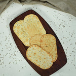Several packs of Maniarr's Spinny Ragi Diet Thins stacked, emphasizing the healthy snack option.