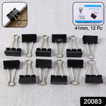 Close-up of metal binder clips holding thick paper securely
