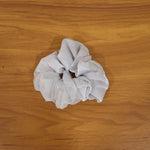 Model wearing elegant satin mesh hair scrunchie with a stylish hairstyle