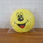 Smiley face plush pillow cushion in a colorful kids’ room setting