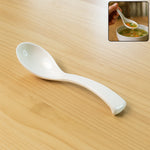 Plastic soup spoon with deep bowl and ergonomic handle in white