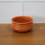 Terracotta serving bowl in a live kitchen setting